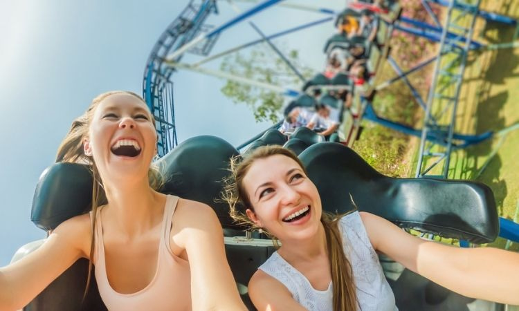 Two girls screaming on a rollercoaster ride