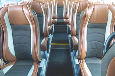Interior of a charter bus with brown seats