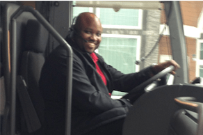 Thomas smiling in his bus driver seat.