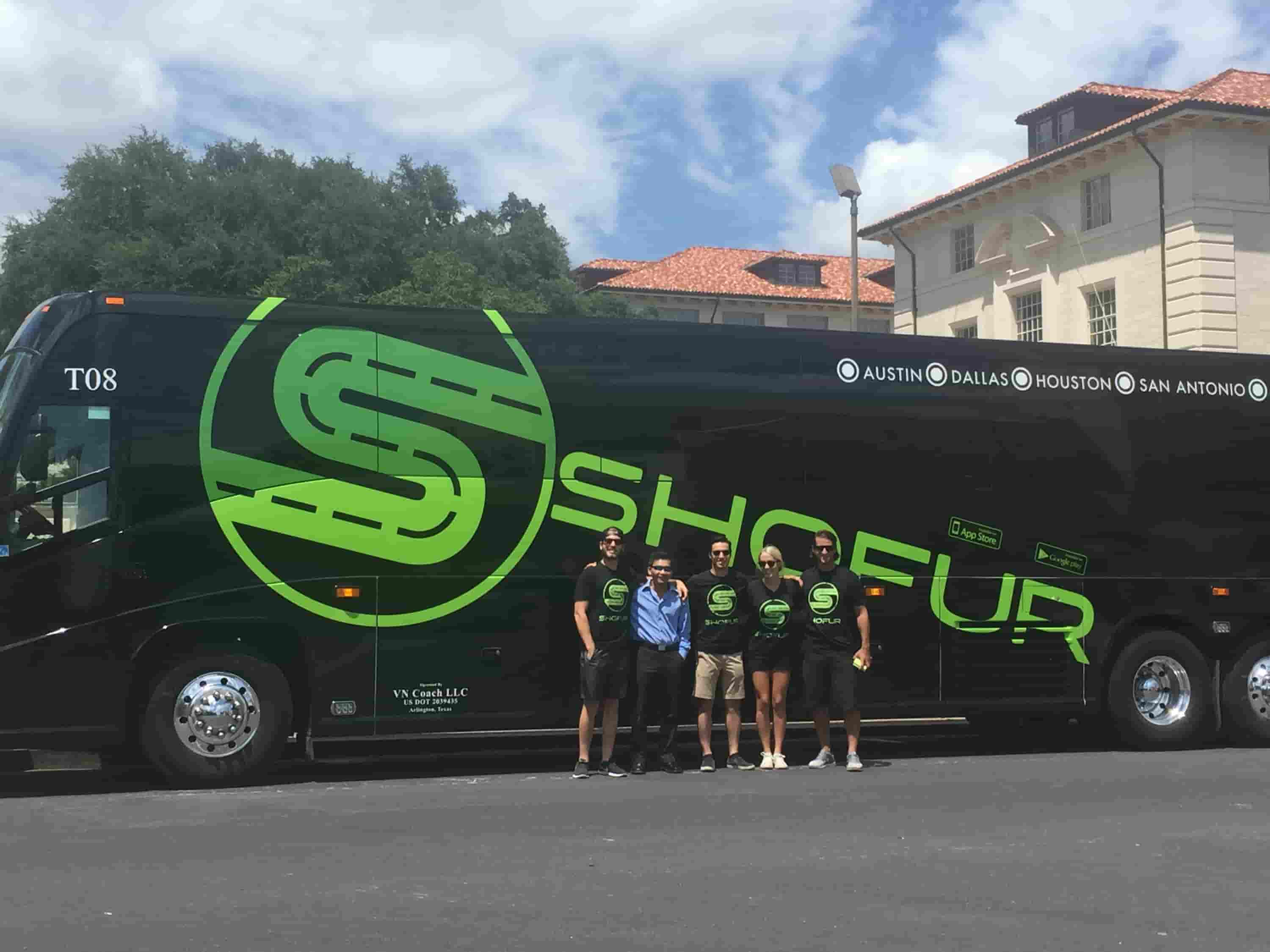 Tim and four other people standing in front of a Shofur charter bus.