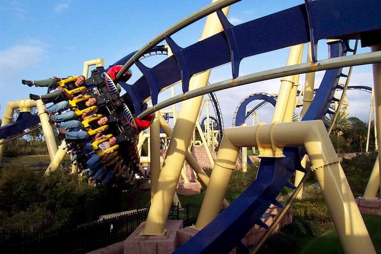 busch gardens visitors smile and scream as they roar around a turn on a roller coaster