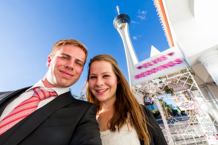 A young couple in front of a wedding chapel in Las Vegas