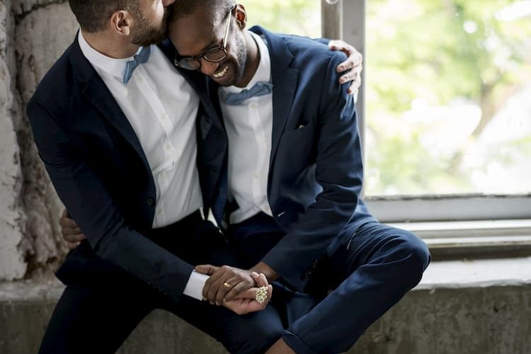Two grooms embracing