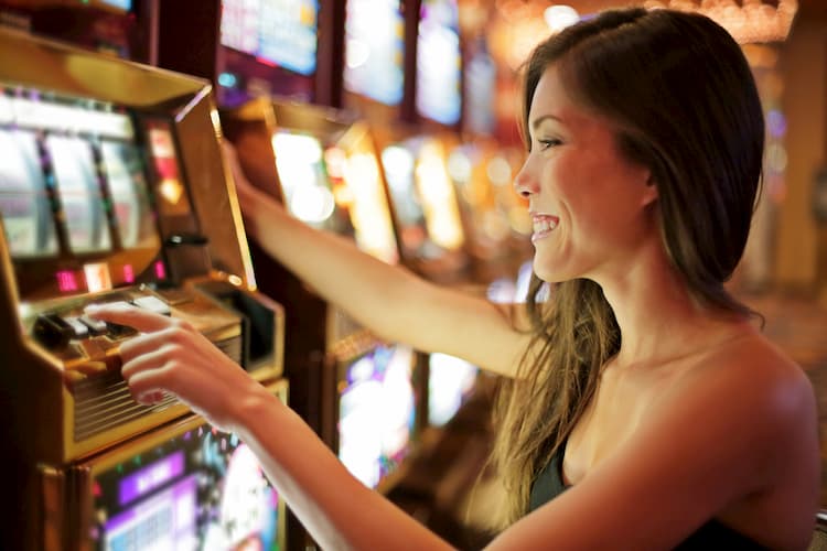 Woman at casino playing slot machine